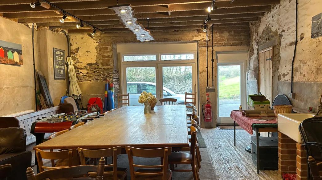 The Barn interior including large table at Spreacombe Holiday Cottages