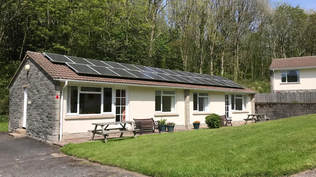 An exterior view of Begonia Cottage at Spreacombe Holiday Cottages showing the solar panels on the roof
