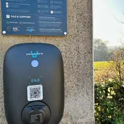 A close up view of an electric vehicle charger with instructions on how to use it