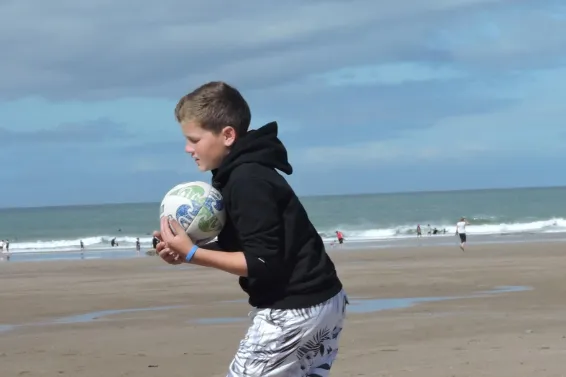 Boy playing with a ball on the beach