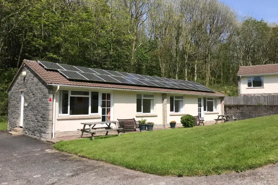 An exterior view of Begonia Cottage at Spreacombe Holiday Cottages showing the solar panels on the roof