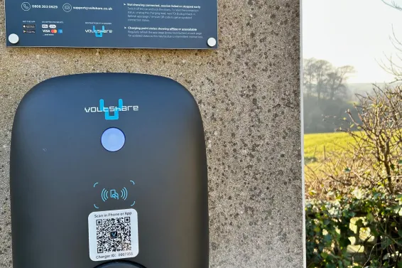 A close up view of an electric vehicle charger with instructions on how to use it