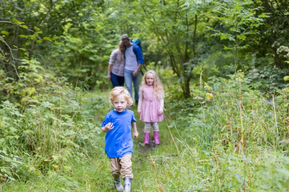 Young family on holiday walking in nature