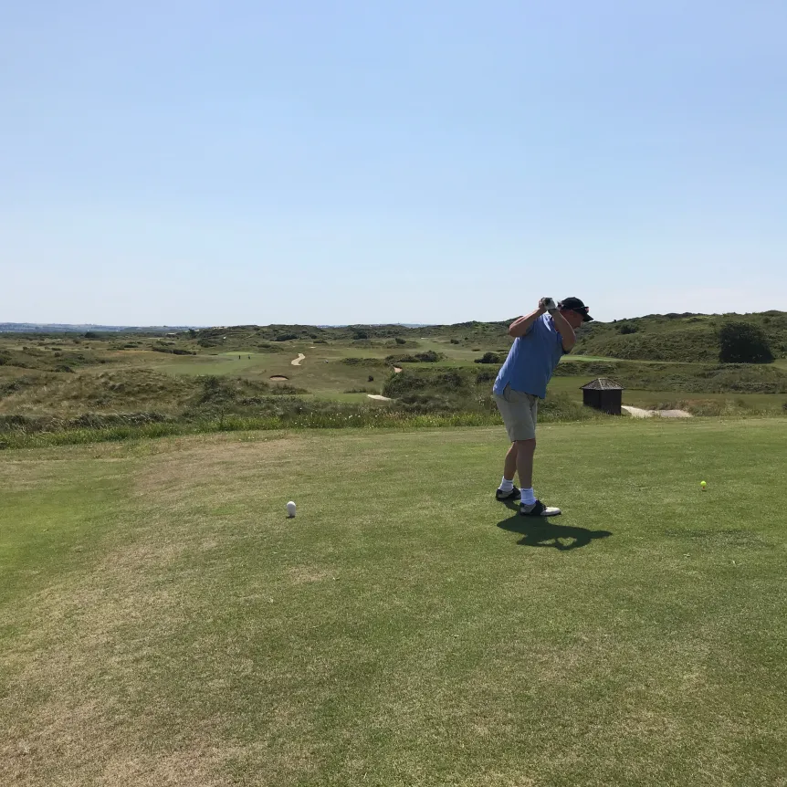 Hitting a golf ball from the first tee at Saunton Sands Golf Club