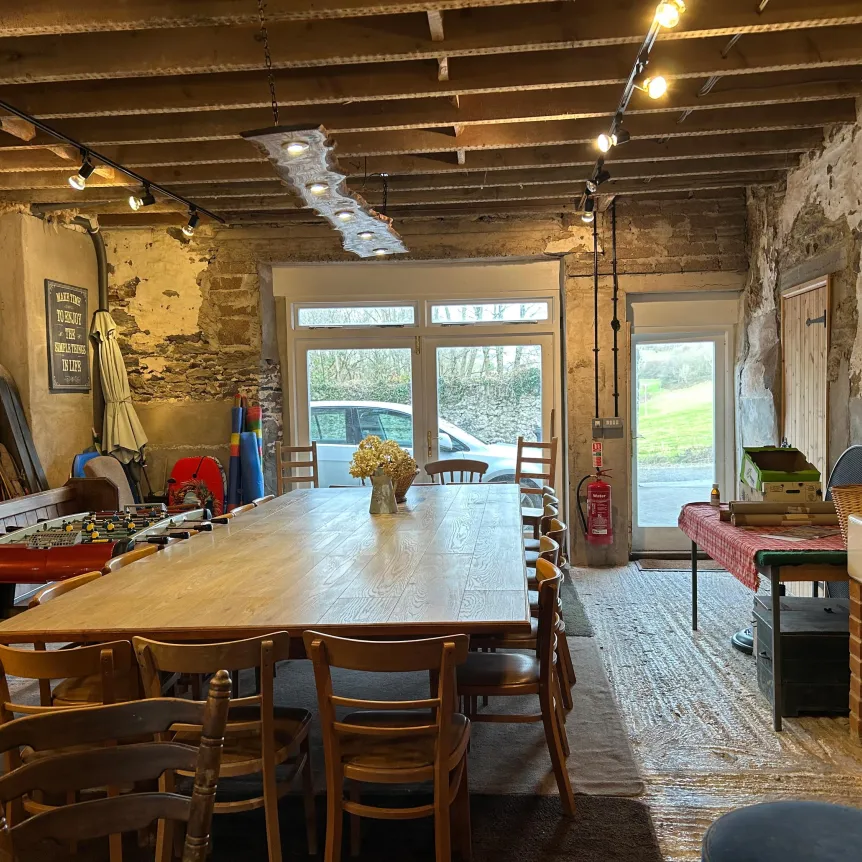 The Barn interior including large table at Spreacombe Holiday Cottages