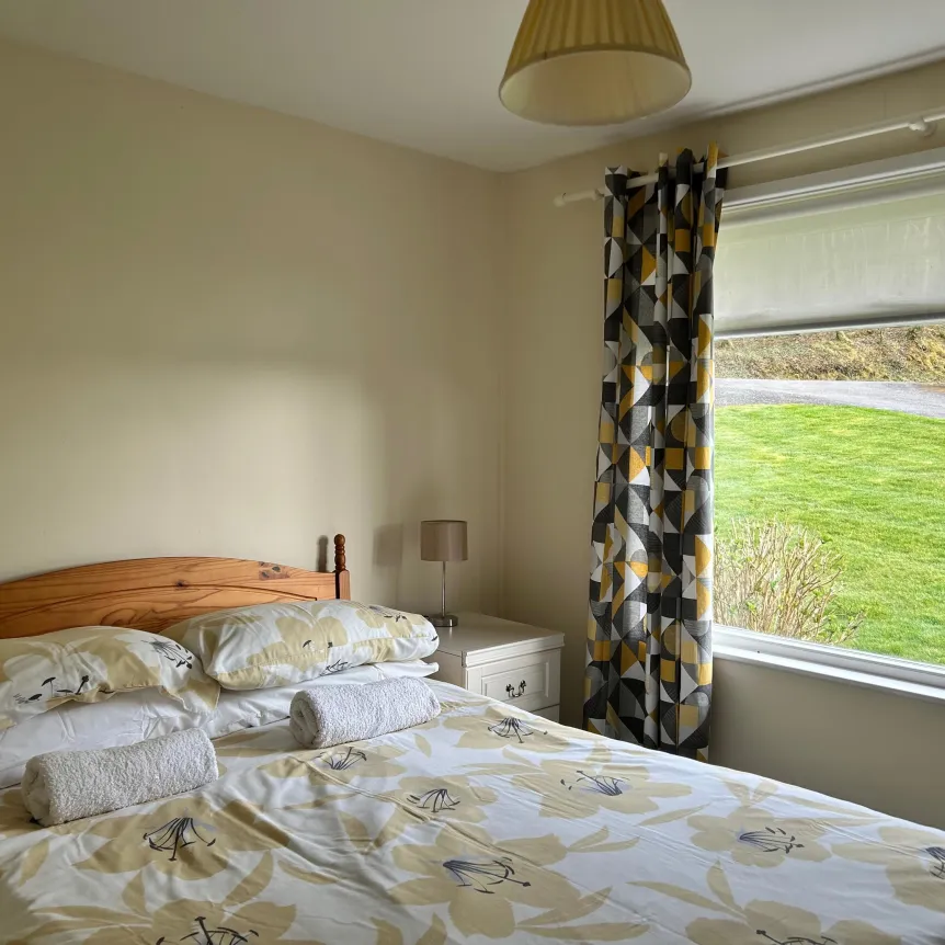 A double bedroom with views over the lawns in Begonia Cottage at Spreacombe Holiday Cottages