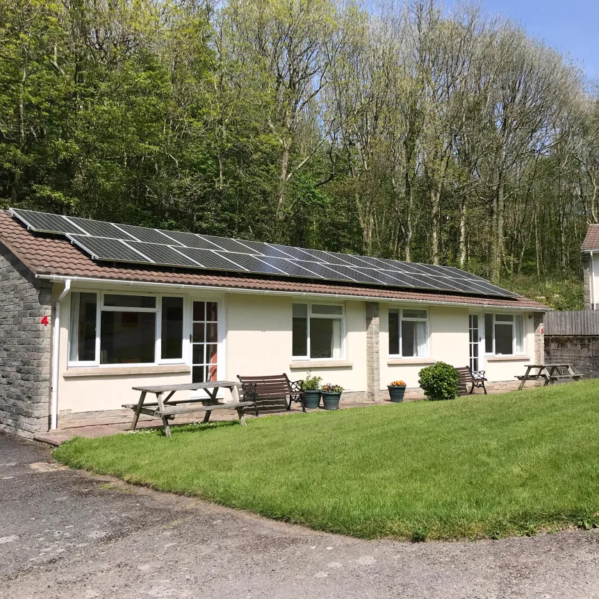 An exterior view of Begonia Cottage at Spreacombe Holiday Cottages showing the solar panels on the roof