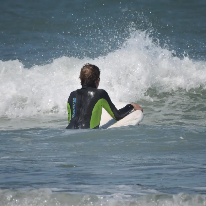 A person approaching a wave with a bodyboard