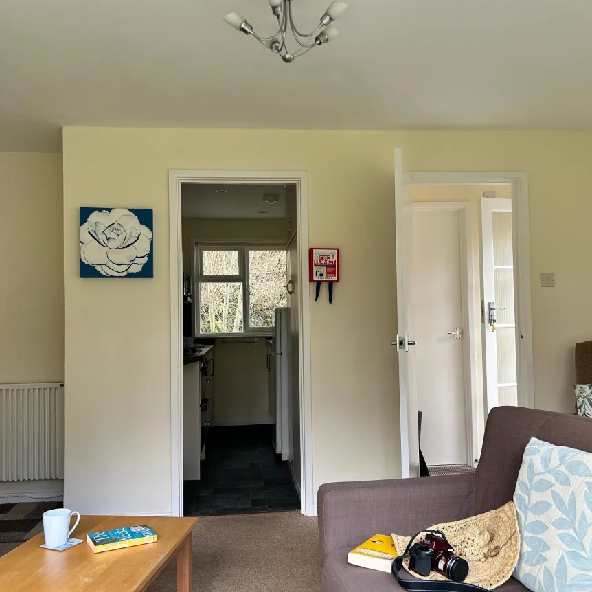 A view across the lounge to the kitchen inside Camellia Cottage at Spreacombe Holiday Cottages