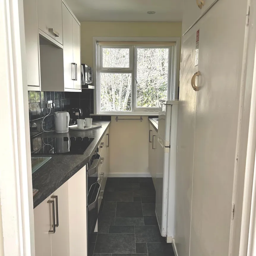 The kitchen area viewed from the lounge doorway in Camellia Cottage at Spreacombe Holiday Cottages