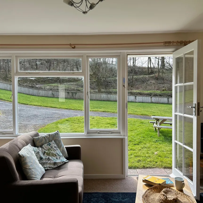 A view over the lawns from the lounge in Camellia Cottage at Spreacombe Holiday Cottages