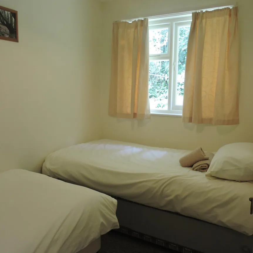 The twin bedroom inside Clematis Cottage at Spreacombe Holiday Cottages