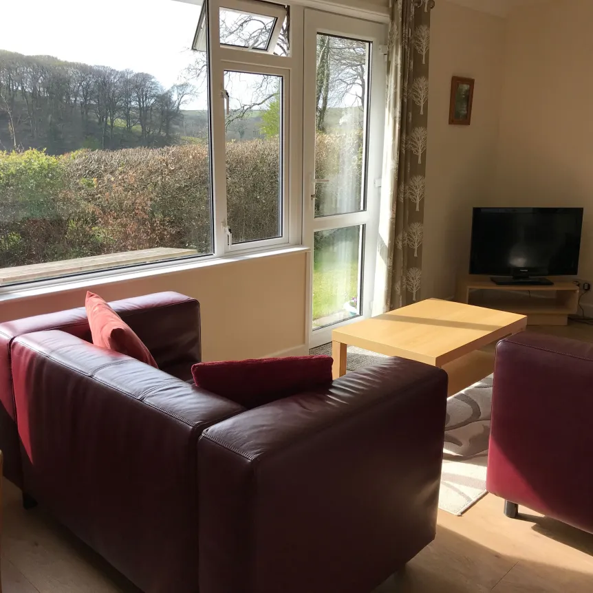 The lounge in Fuchsia Cottage overlooking the surrounding countryside at Spreacombe Holiday Cottages