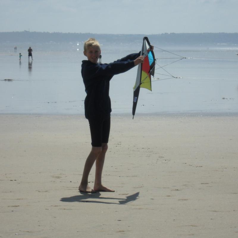 teenager flying a stunt kite