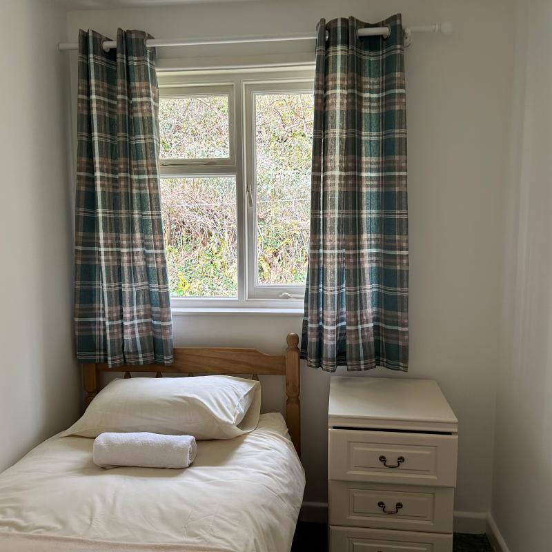 single bed, chest of drawers, woodland view