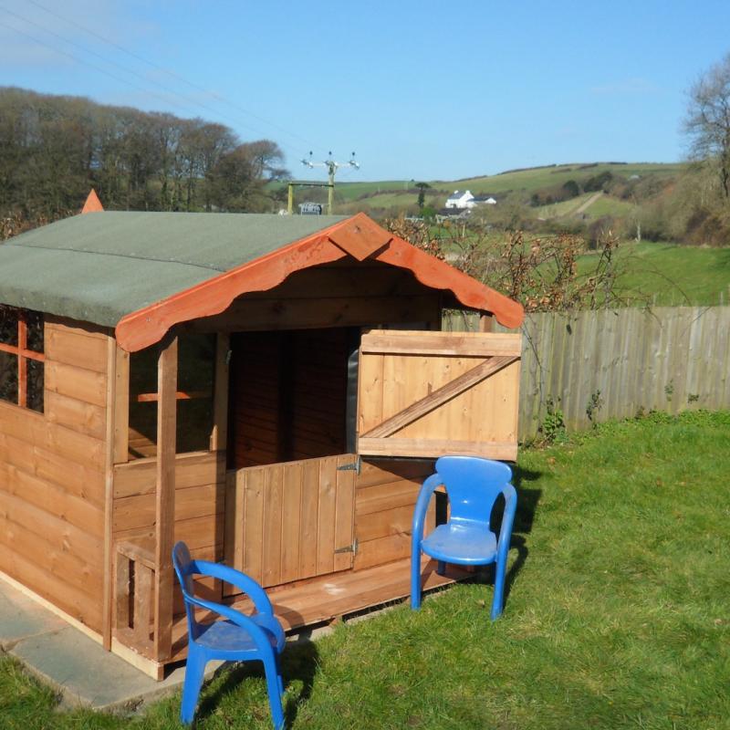 Small playhouse for children and view of the Spreacombe Valley