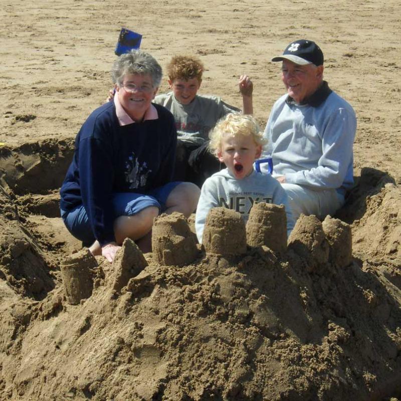 Family having fun on the sandy beach